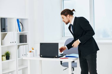 Elinde telefon teknolojisi olan takım elbiseli bir adam.