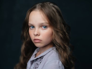 Elbise giymiş, güzel saç stili olan bir kız.