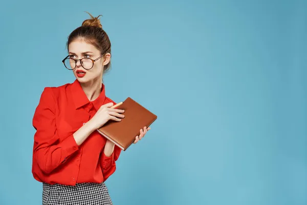 Mulher em camisa vermelha com bloco de notas e secretária caneta escritório de trabalho — Fotografia de Stock