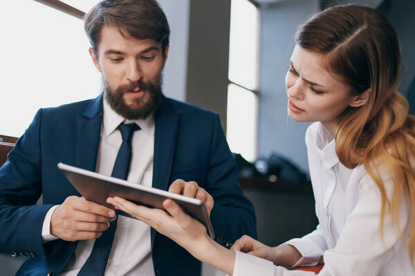 business man and woman work with a tablet officials teamwork