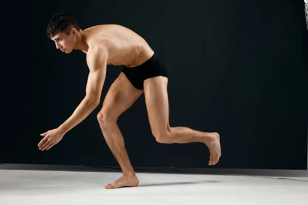 Чоловік культурист оголена мускулисте тіло в чорних трусиках позує студію — стокове фото