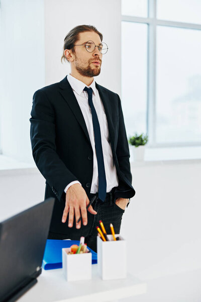 man in a suit in the office with documents executive