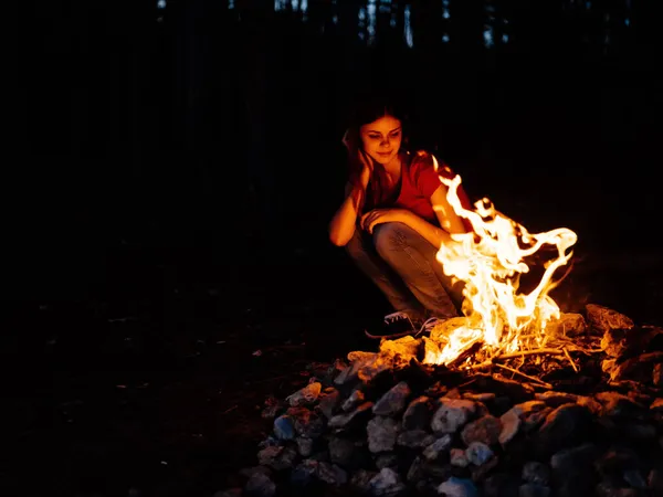 모닥불 숲 근처 자연 속에 앉아 있는 여자 — 스톡 사진