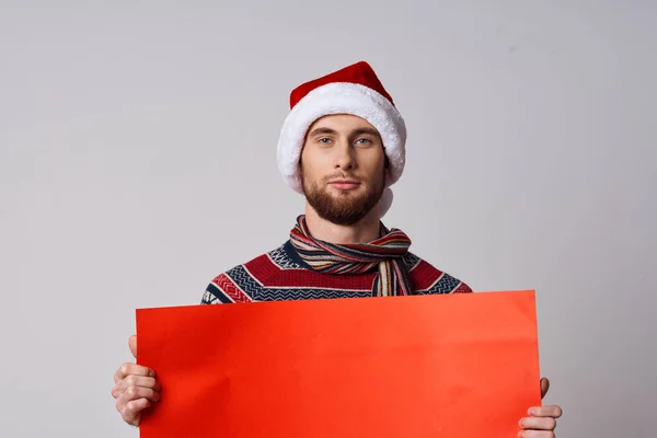 handsome man Red paper billboard advertising christmas light background