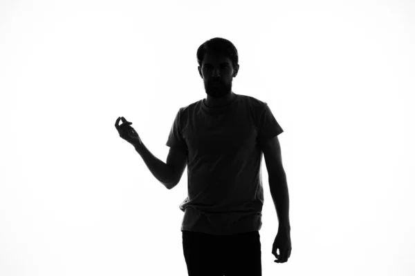 Hombre haciendo gestos con sus manos en las sombras posando estudio de incógnito — Foto de Stock