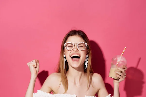 Jolie femme un verre avec un verre fond rose — Photo