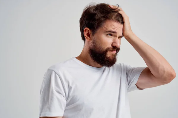Emotional man holding his head pain stress emotions light background — Stock Photo, Image