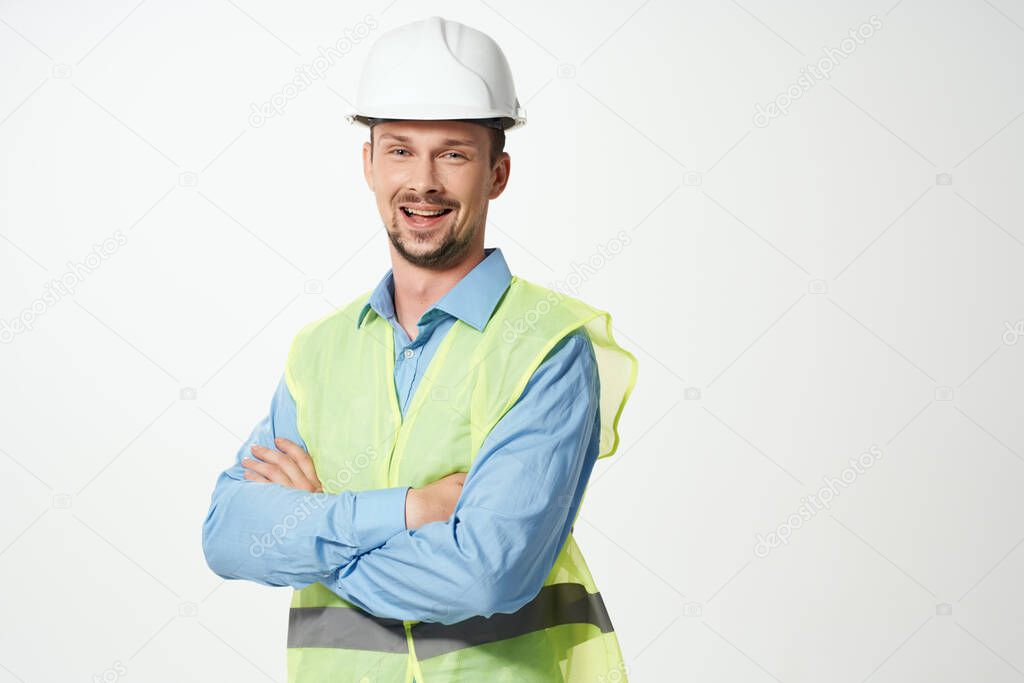 Male builder Professional working uniform light background