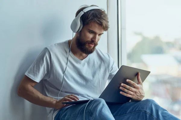bearded man with laptop entertainment technologies. High quality photo