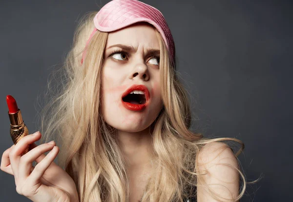 woman with smeared lipstick on  dark background. High quality photo