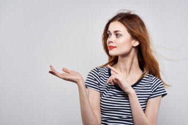 Çizgili tişörtlü güzel bir kadın. Kırmızı dudaklar. El modeli stüdyosu.