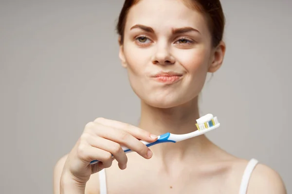 Woman with a toothbrush in hand morning hygiene isolated background — Stock Photo, Image