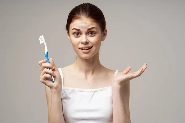 Cheerful woman toothpaste brushing teeth dental health light background — Stock Photo, Image