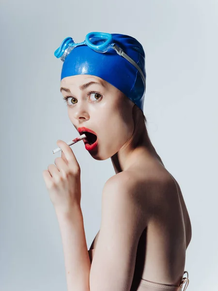 穿着泳镜的女运动员在与世隔绝的背景下吸烟 高质量的照片 — 图库照片