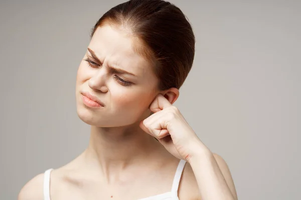 sick woman with ear pain on  light background. High quality photo
