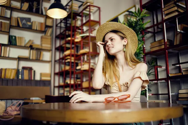 Χαρούμενη γυναίκα που διαβάζει ένα βιβλίο σε μια καφετέρια επικοινωνίας — Φωτογραφία Αρχείου