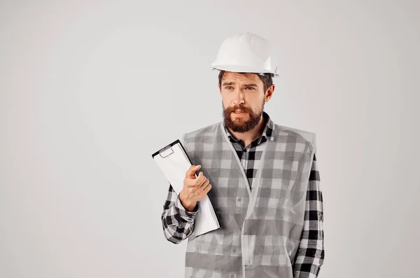 Construtor masculino em um capacete branco blueprints indústria estúdio profissional — Fotografia de Stock