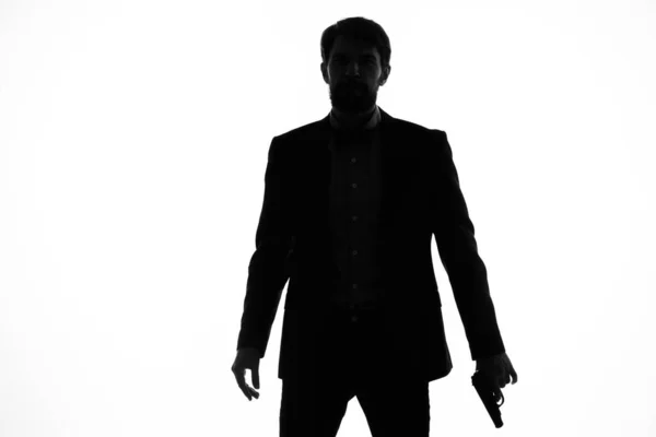 Man gun in the hands of the emotions silhouette posing studio — Stock Photo, Image