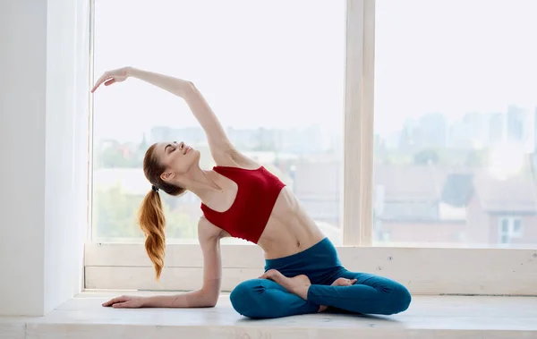 Woman near window yoga asana exercise — Stock Photo, Image