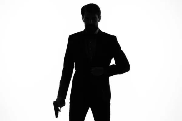 Чоловік у костюмній зброї в руках емоцій силует світлого фону — стокове фото