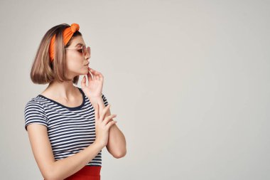 Güneş gözlüğü takan güzel bir kadın moda dekorasyonu yapıyor.