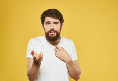 Beyaz tişörtlü adam hoşnutsuz görünüyor.