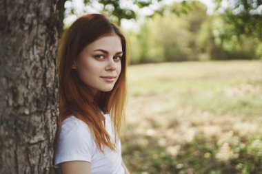 Ağaç doğasının yanında güzel bir kadın. Yaşam tarzı yaz.