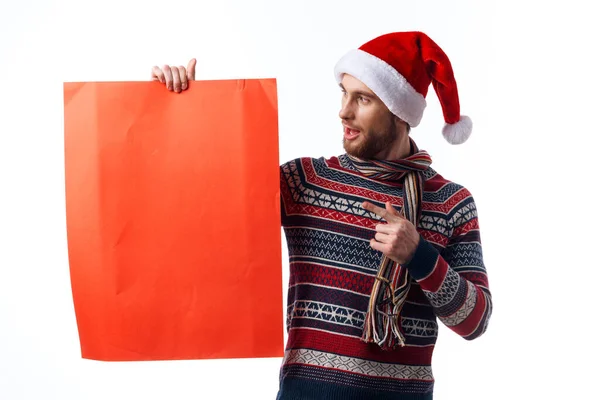 Handsome man in New Years clothes holding a banner holiday light background — Stock Photo, Image