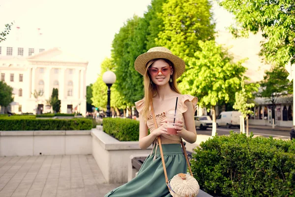 Веселая женщина гуляет по парку с напитком свежий воздух — стоковое фото