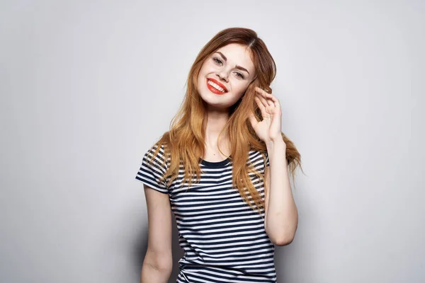 Cheerful woman in a striped t-shirt gesture with his hands model studio — Stock Photo, Image