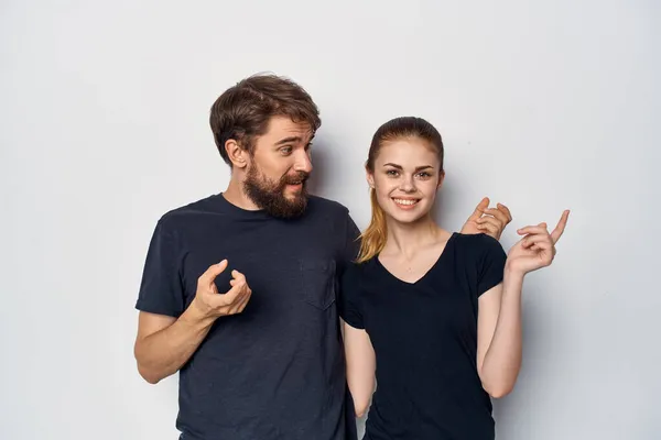 fashionable man and woman in black t-shirt sunglasses posing isolated background