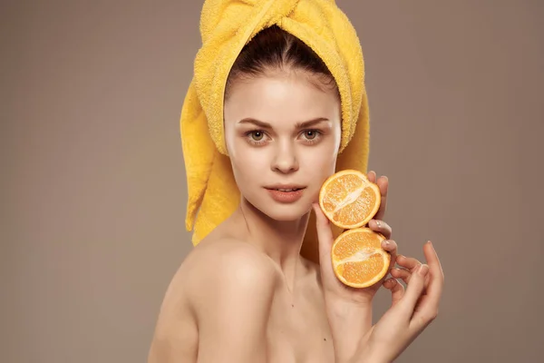 Woman with a towel on her head bare shoulders tangerines vitamins clear skin — Stock Photo, Image