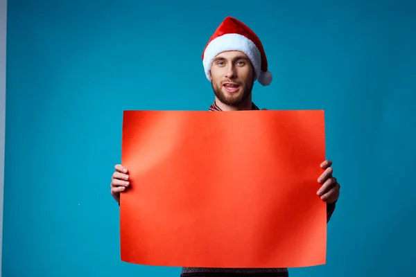 Emotional man in a christmas Orange mockup Poster blue background — Stock Photo, Image