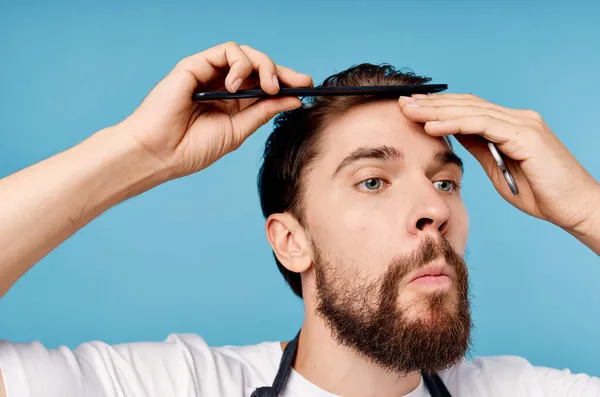 bearded man modern hairstyle blue background