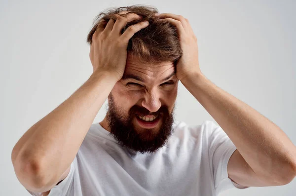 man holding his head pain stress emotions isolated background