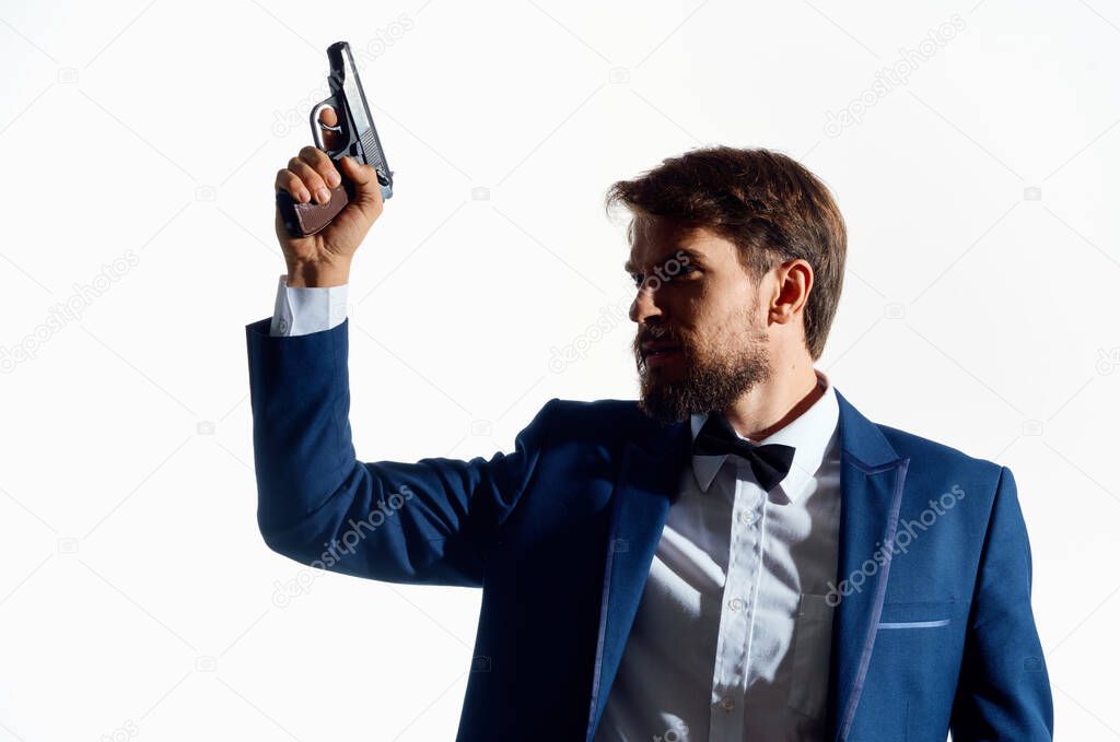 male Agent with a gun in hand Studio emotions