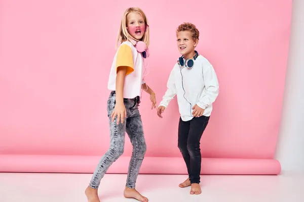 Μοντέρνο αγόρι και κορίτσι μοντέρνα ρούχα ακουστικά διασκέδαση Ακούγοντας μουσική — Φωτογραφία Αρχείου