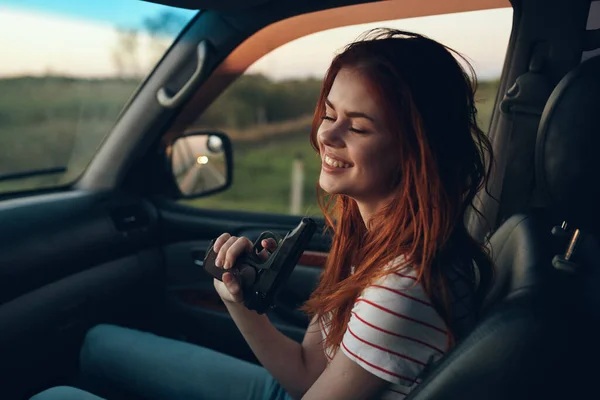 Cheerful woman in car trip journey road