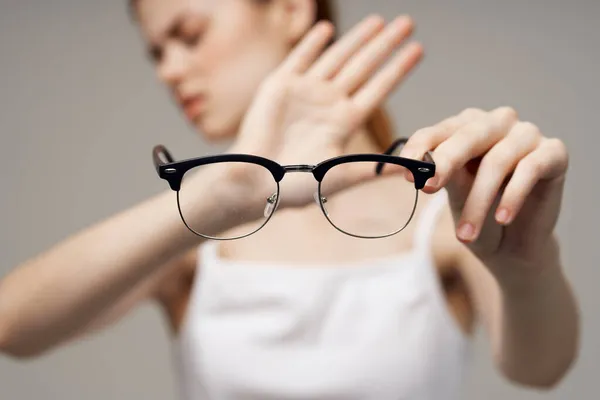 Óculos de mulher nas mãos de tratamento de estúdio astigmatismo — Fotografia de Stock