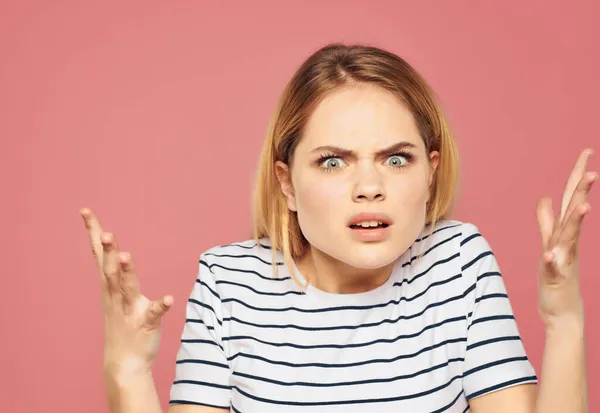 Schöne Frau in einem gestreiften T-Shirt Unzufriedenheit gestört Studio rosa Hintergrund — Stockfoto