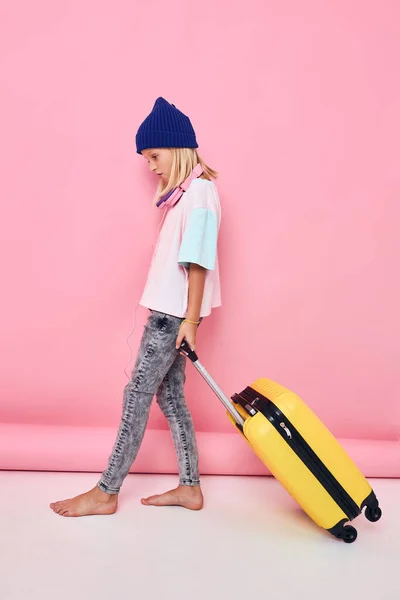 可愛い女の子で青い帽子のスーツケース休暇子供時代 — ストック写真