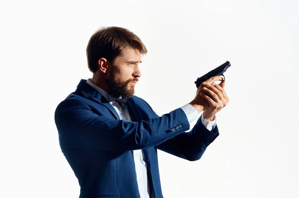 Male Agent with a gun in hand isolated background — Stock Photo, Image