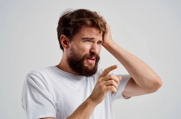 Emotionele man houdt zijn hoofd pijn stress emoties geïsoleerde achtergrond — Stockfoto