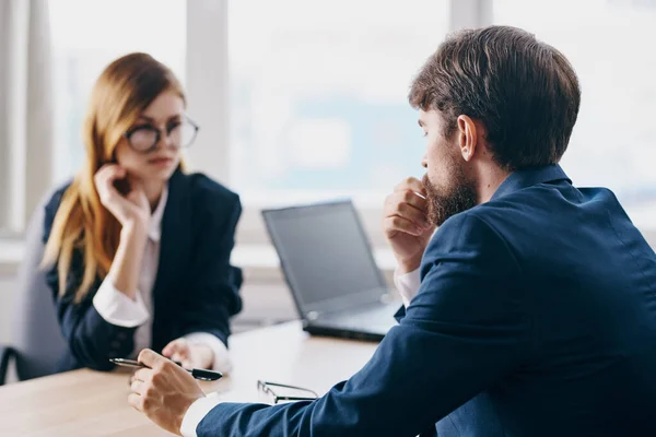 managers in the office in front of a laptop career network professionals