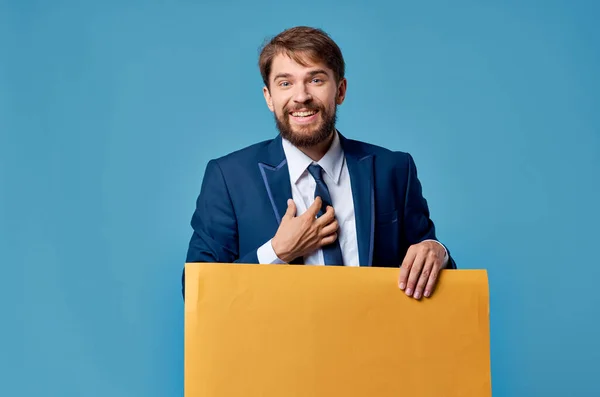Szakállas férfi sárga hirdetőtábla reklám másolás tér kék háttér — Stock Fotó