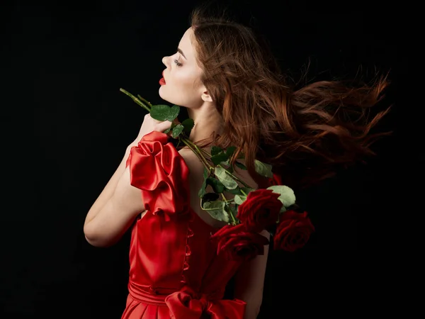 Woman in red dress flowers gift luxury romance Royalty Free Stock Photos