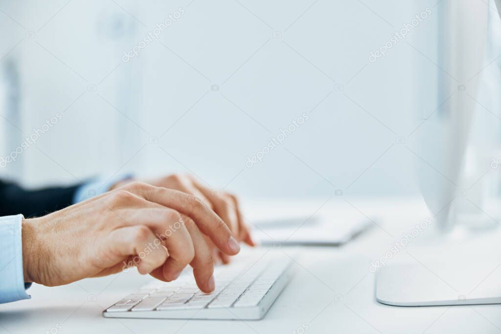 keyboard on desktop hands typing close up