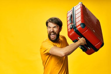 duygusal adam kırmızı bavul sarı arka plan