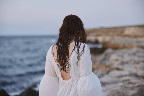 Woman outdoors landscape ocean stones travel unaltered — Stock Photo, Image