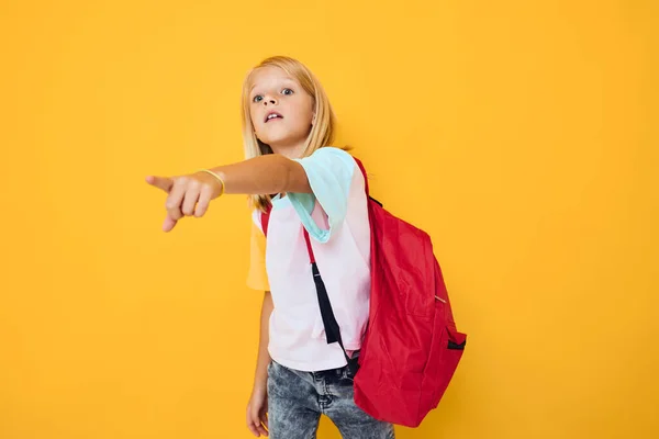 Little girl blonde hair school backpack posing yellow color background — Fotografia de Stock
